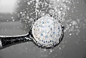 Shower head spraying freshly filtered water from a treatment system.